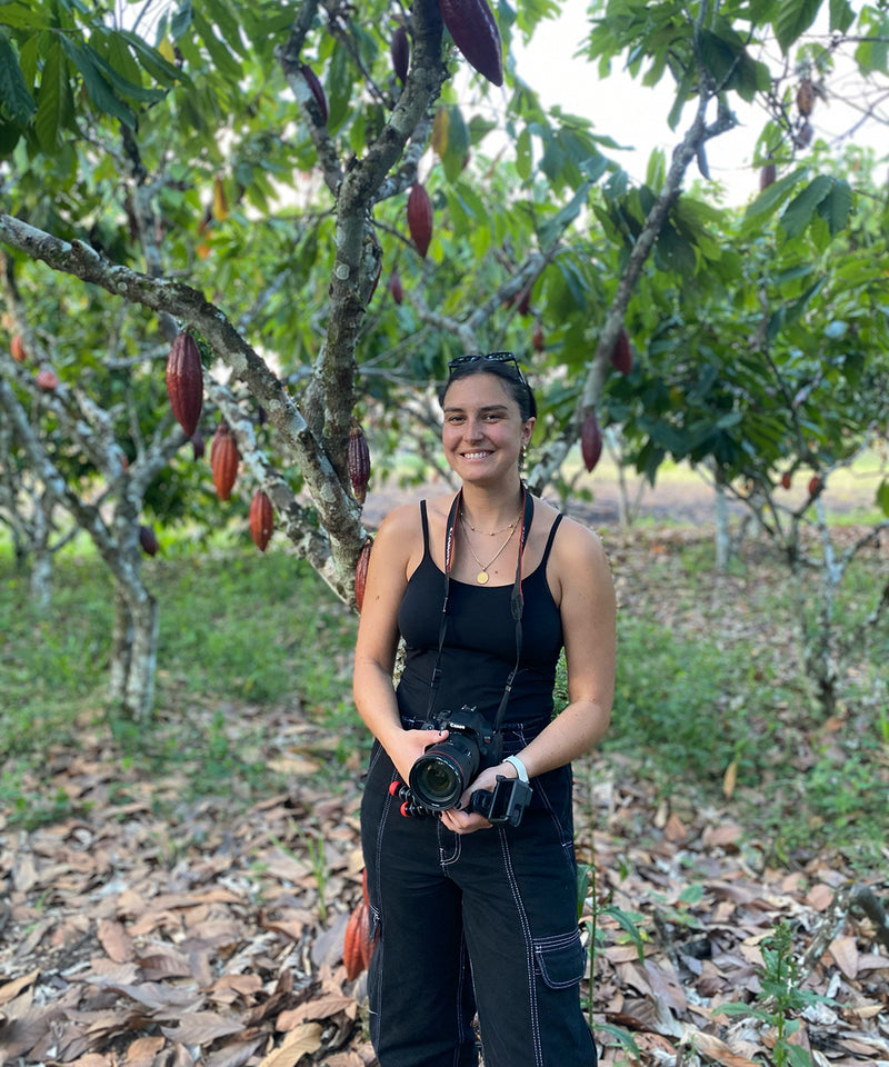 jcoco chocolate's ellie standing among cacao trees in peruvian farm